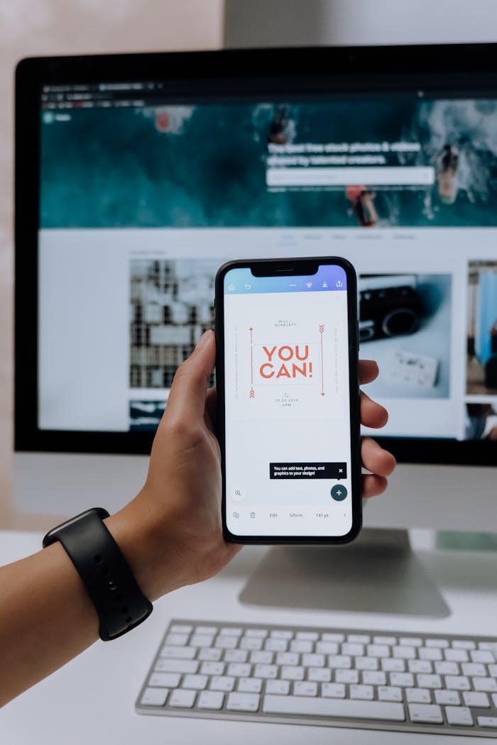 The Art of Drawing Readers In: Your attractive post title goes here Hand holding smartphone with 'You Can!' message in front of desktop screen.