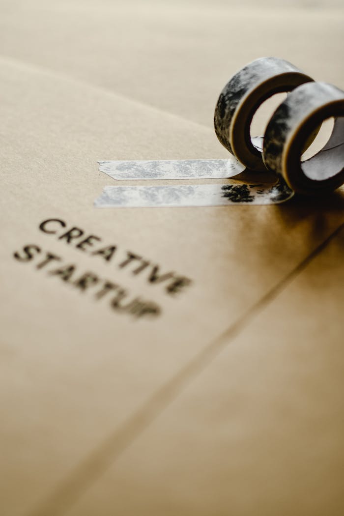 Crafting Captivating Headlines: Your awesome post title goes here Brown paper with 'Creative Startup' text and decorative tapes for artistic projects.